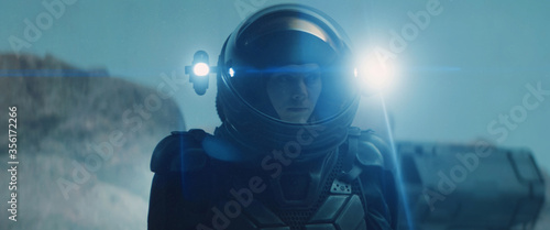 Fotografia Caucasian female astronaunt wearing a space suit exploring planet surface, night