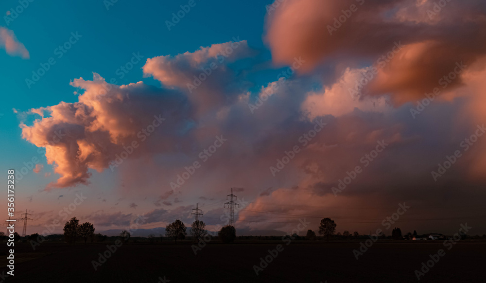Beautiful sunset with dramatic clouds near Tabertshausen, Bavaria, Germany Beautiful sunset with dramatic clouds near Tabertshausen, Bavaria, Germany
