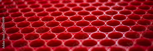 recycling plastic concept. red abstract background of plastic caps from a bottle, top view, short focus