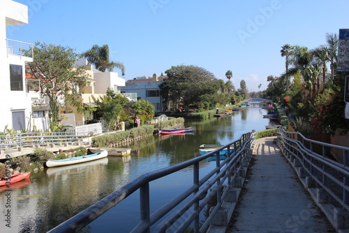 Houses, boats and green trees along a serene canal in California  © Maria_Wang