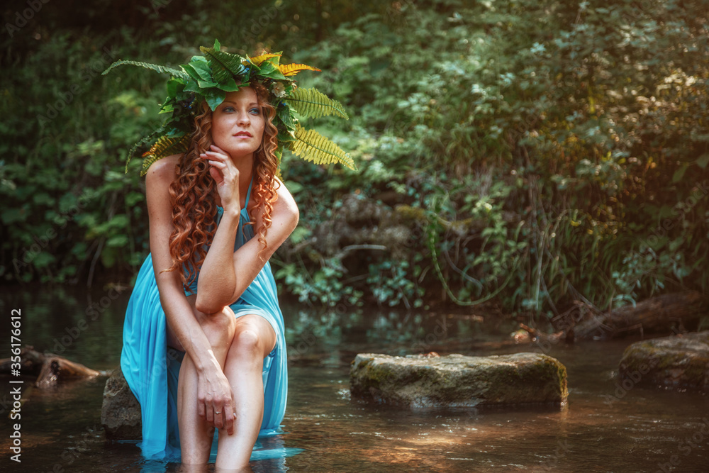 Fototapeta premium a beautiful young woman celebrates in the woods the solstice day