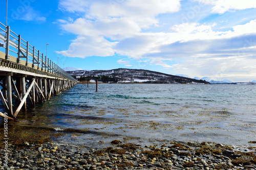 beautiful old bridge crossing two islands over ocean in sunshine