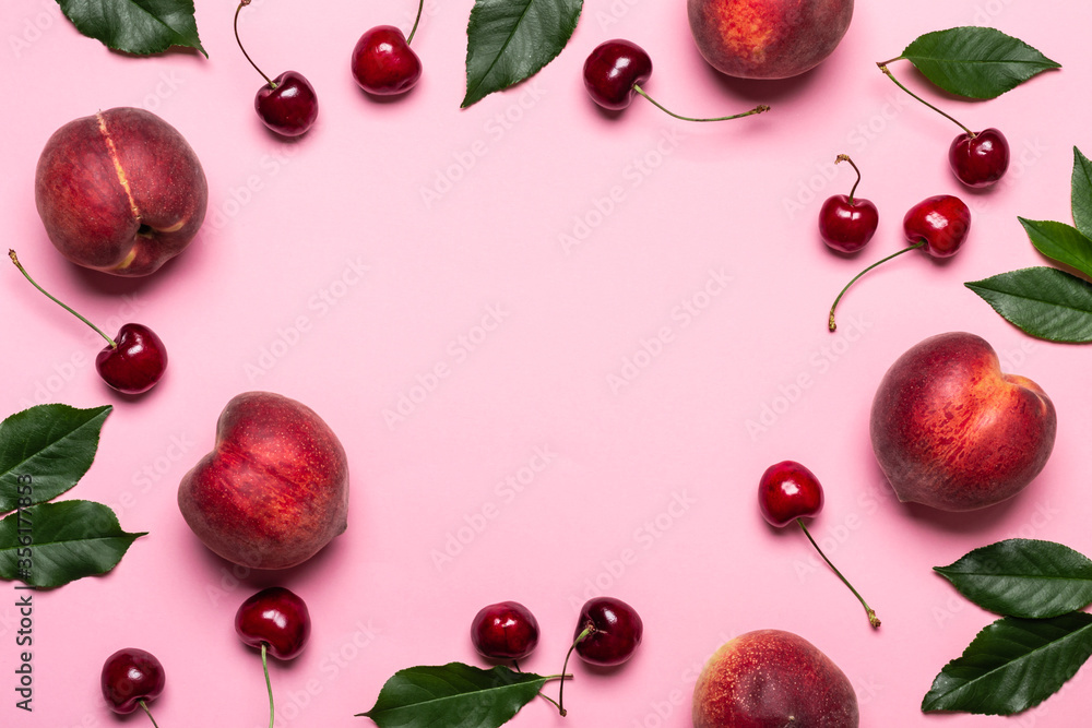 Pink summer background with frame of ripe peaches and cherries, copy space - obrazy, fototapety, plakaty 