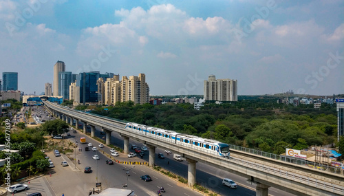 Aerial shot of Rapid metro tracks in urban areas of Delhi NCR, Gurgaon, Noida with metro running on the tracks. A very useful addition to existing DMRC rail network photo
