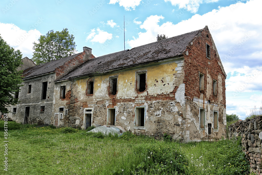 Large abandoned brick house with glassless windows
