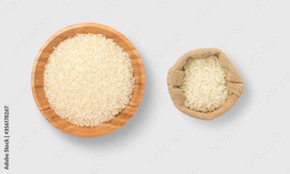 Rice in a wooden bowl and sack on a white background Rice in a wooden bowl and sack on a white background