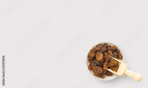 Raisins in a bowl on a white background