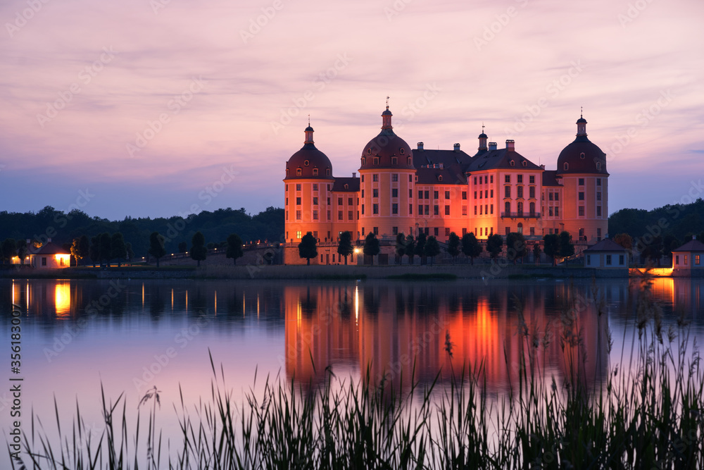 Fototapeta premium The castle in Moritzburg, Germany in the evening with reflection in the water.