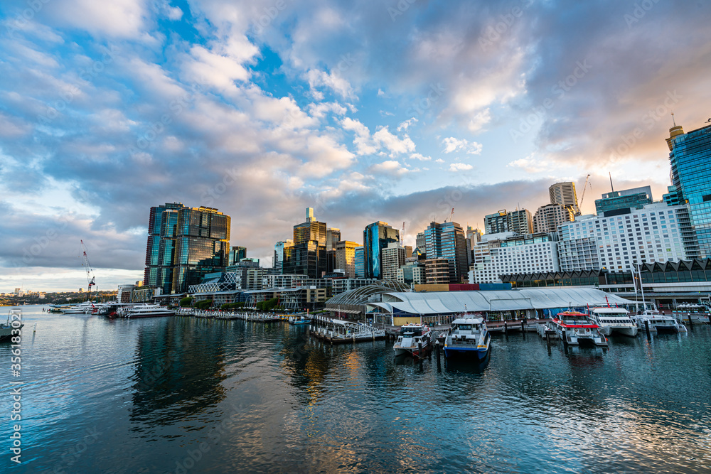 Sydney downtown skyline at Darling Harbor bay, business and recreational arcade, in Sydney, NSW, Australia at sunrise