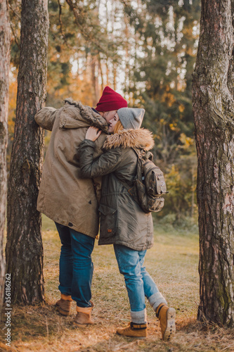 Hiking couple with backpack walking in the forest and exploring outdoors. Freedom and active travel concept.