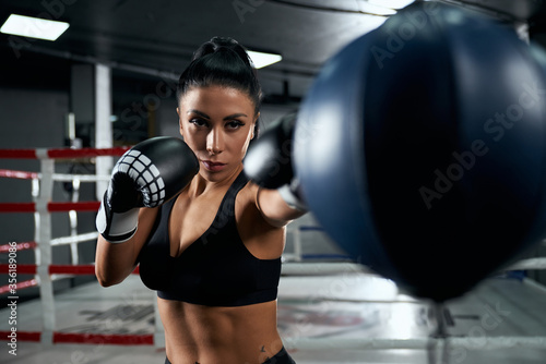 Female fighter training in boxing gloves.