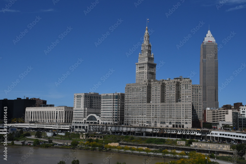 The Terminal Tower with blue sky. The terminal tower is a 52-story, landmark skyscraper located in Public Square in downtown Cleveland Ohio. The Terminal Tower with blue sky. The terminal tower is a 52-story, landmark skyscraper located in Public Square in downtown Cleveland Ohio.