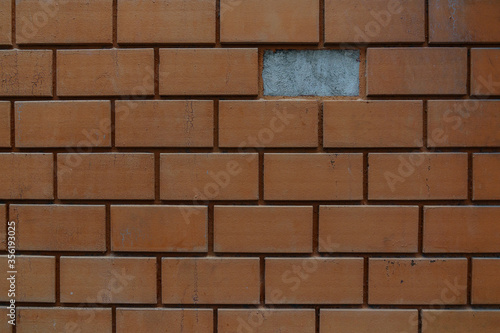 Red brick wall with missing pieces