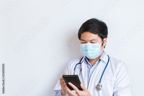 Coronavirus Covid-19 and Air pollution pm2.5 concept. doctor wearing mask for protect pm2.5 and make notes on the notebook at home. Covid19 coronavirus and epidemic virus symptoms.