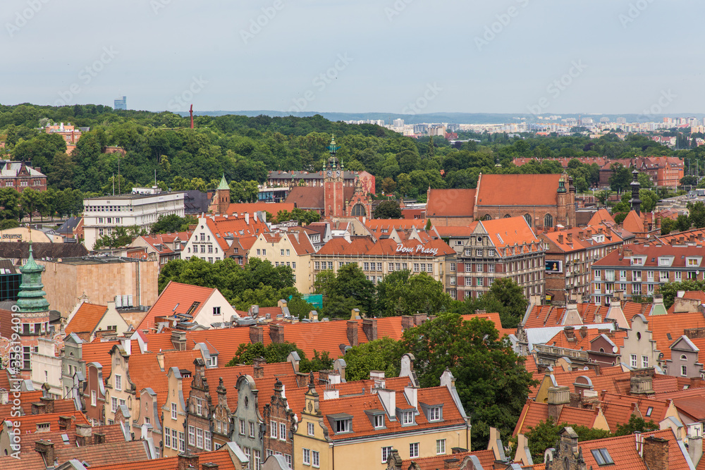 Gdansk, Poland - Juny, 2019: Red roofs, old buildings and colorful houses in Old Town Stare Miasto in Gdansk, aerial view from cathedral St. Mary's Church tower, Poland