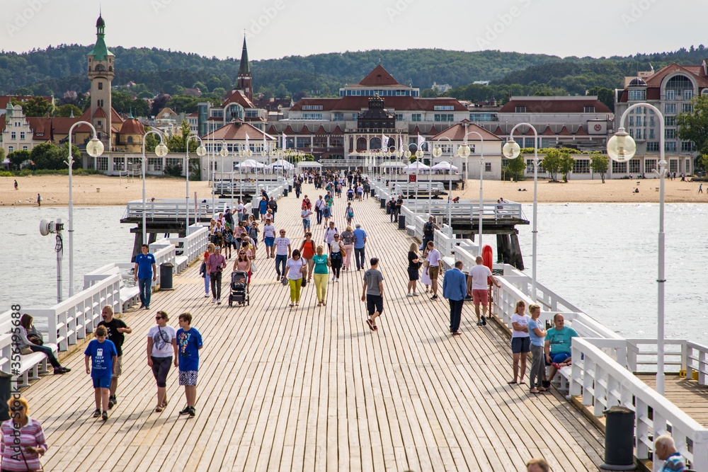 Obraz premium Sopot, Poland - Juny, 2019: The Sopot Pier in the city of Sopot built in 1827. At 511m, the pier is the longest wooden pier in Europe in Sopot, Poland.