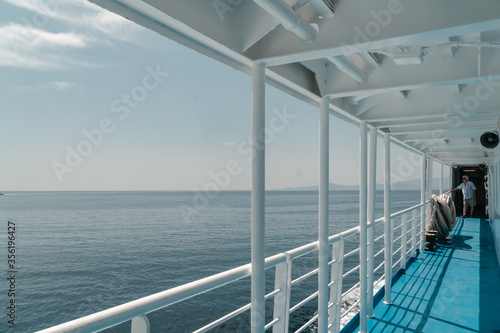 Blue and white ferry in the sea. Passenger boat in Aegean Sea in Greece. Summer travel