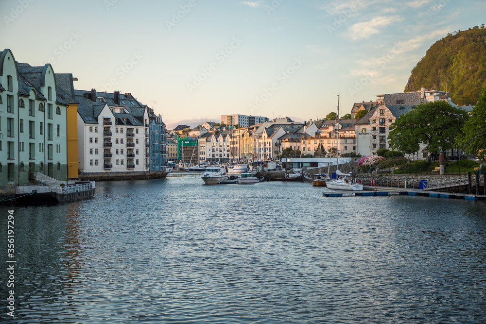 Gdansk, Poland - Juny, 2019: Scenic secessionist houses in european Alesund town reflected in water at Romsdal region in Norway - obrazy, fototapety, plakaty 
