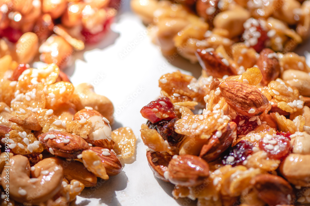 The process of making homemade cereal cookies, Is an easy-to-make food for health lovers,Cashew,Almonds,Corn cereal,raisin,Dried Strawberries,White sesame ,honey,egg white, Selective focus. The process of making homemade cereal cookies, Is an easy-to-make food for health lovers,Cashew,Almonds,Corn cereal,raisin,Dried Strawberries,White sesame ,honey,egg white, Selective focus.