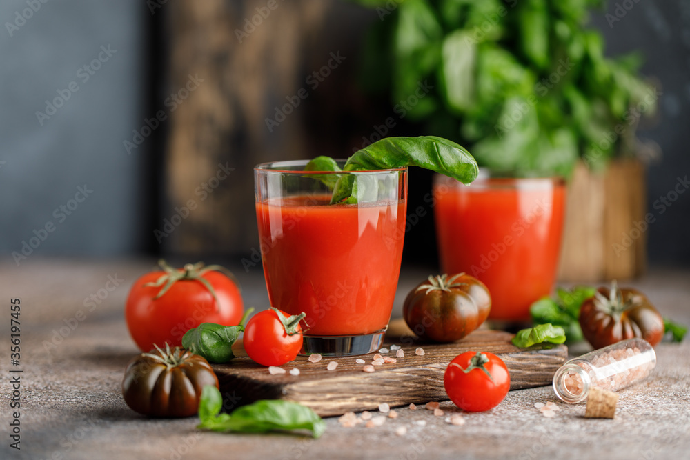 Tomato juice and fresh tomato with basil on rustic background Tomato juice and fresh tomato with basil on rustic background