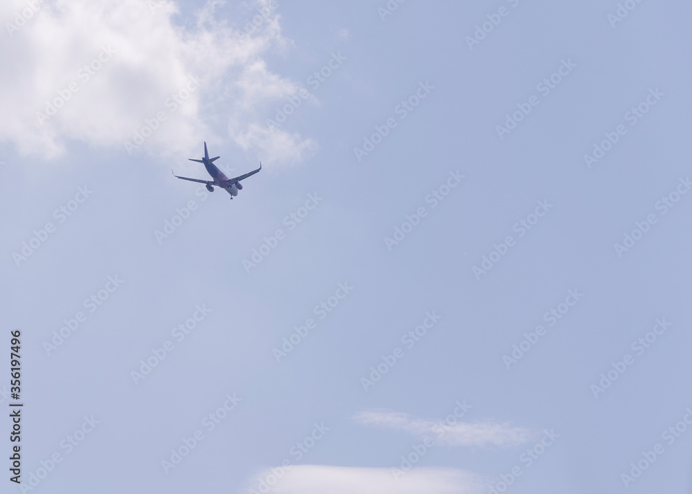 plane flying away into the distance against a blue sky plane flying away into the distance against a blue sky