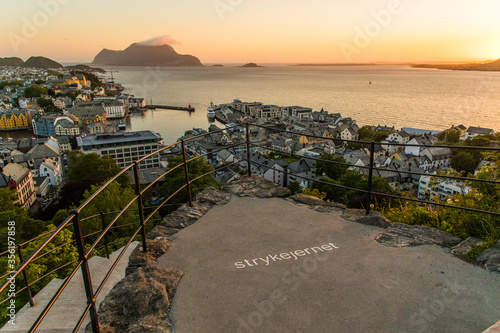 Gdansk, Poland - Juny, 2019: Alesund is a port and tourist city at the entrance to the Geirangerfjord. Cityscape image of Alesund at dawn. photo