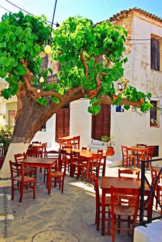 Greece, Skiathos island, tables and chairs outside of a local traditional tavern in the town of Skiathos, May 6 2012. © Theastock