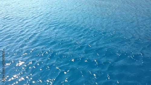 MUGLA, TURKEY: Tilt movement of blue water surface and an island. Warm summer day