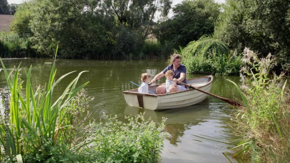 WS TU Father and sons (2-3) sitting in rowboat at pond / Dinton, Wiltshire, United Kingdom WS TU Father and sons (2-3) sitting in rowboat at pond / Dinton, Wiltshire, United Kingdom