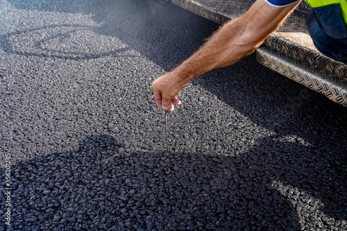 the quality of the work performed, the black asphalt roadbed, a new road, asphalt, gravel, outdoor
