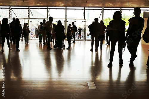 Crowd silhouettes at main entrance of convention center.Turin Italy May 10 2019