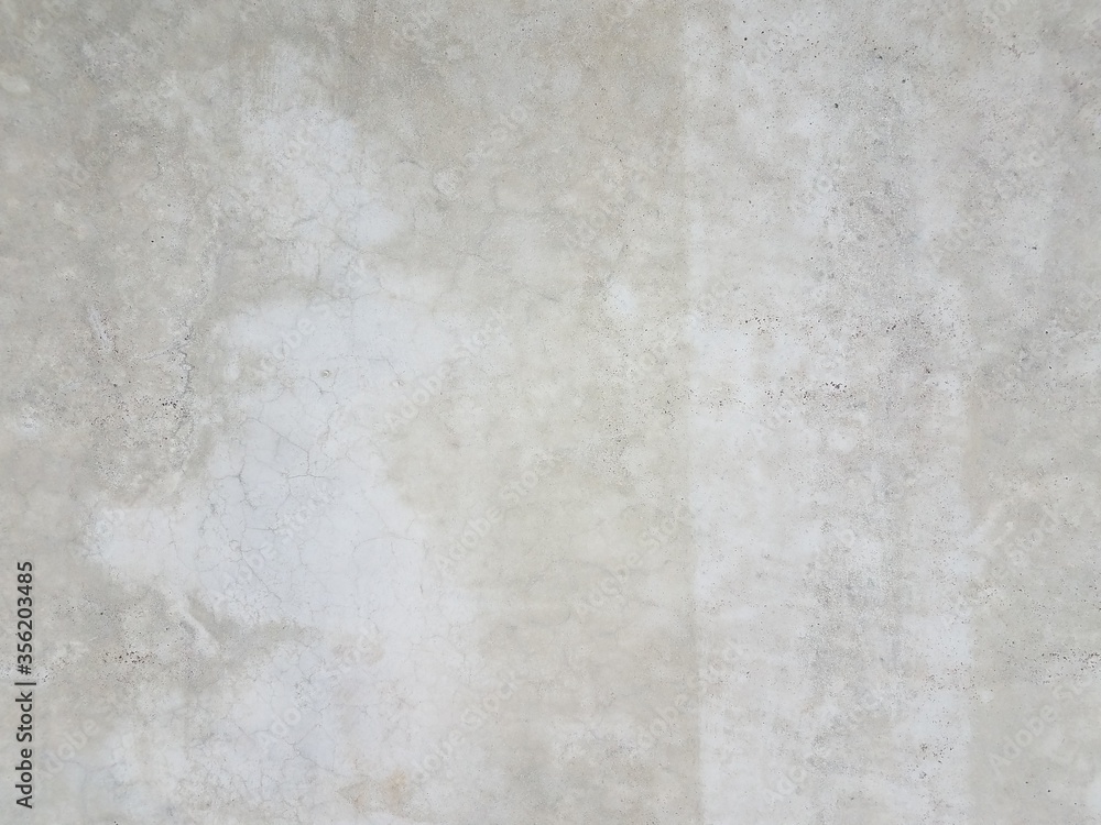 grey cement wall or surface with light patches
