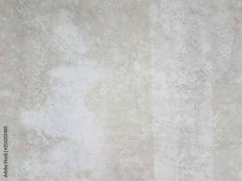grey cement wall or surface with light patches