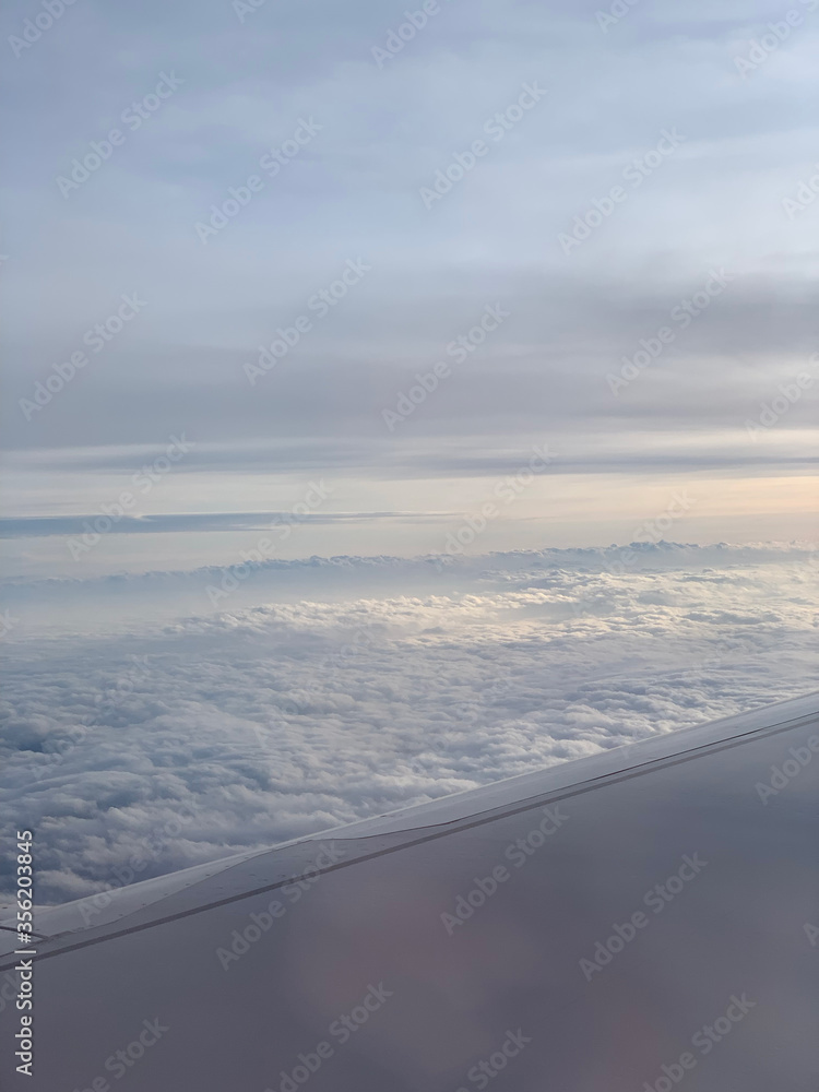 Sunset up above the clouds viewed inflight on a passenger airplane. Sunset up above the clouds viewed inflight on a passenger airplane.