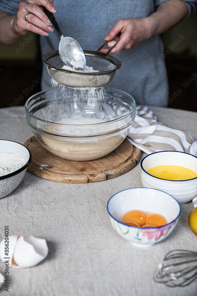 Step by step process of making yeast bread. Adding wheat flour through
