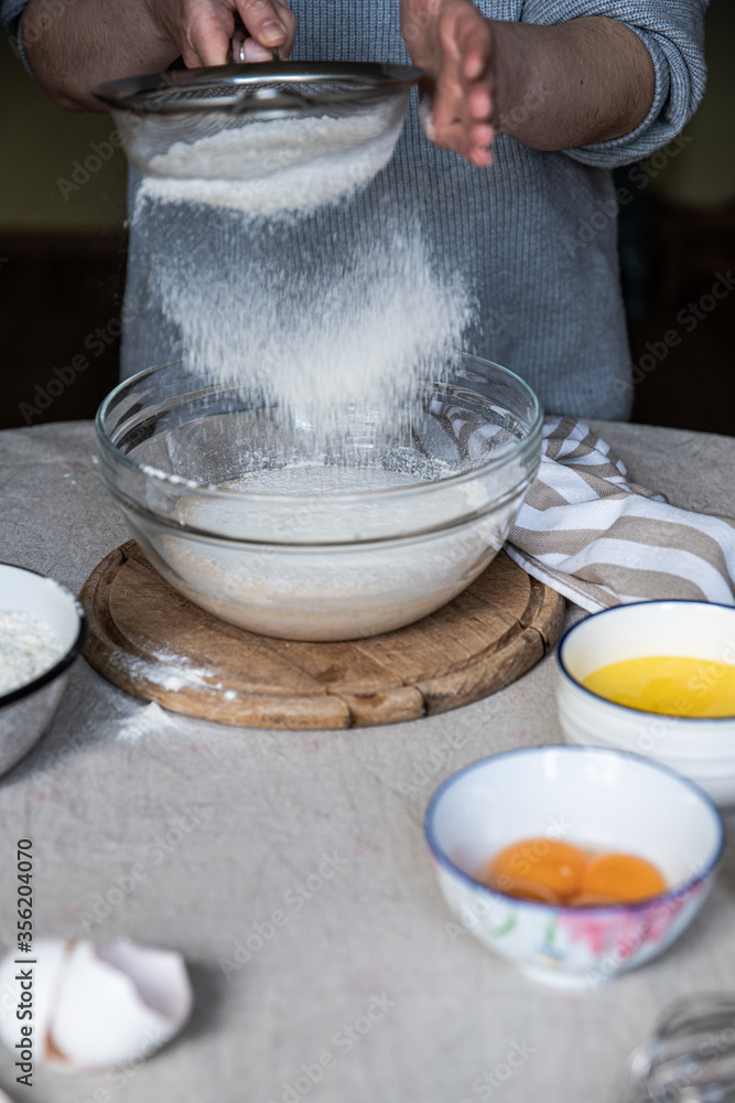 Step by step process of making yeast bread. Adding wheat flour through