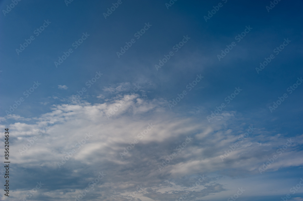 Natural sky composition. Sunny vast blue sky abstract background. Beautiful cloudscape, view over white fluffy clouds. Freedom concept, on the heaven. Element of design.