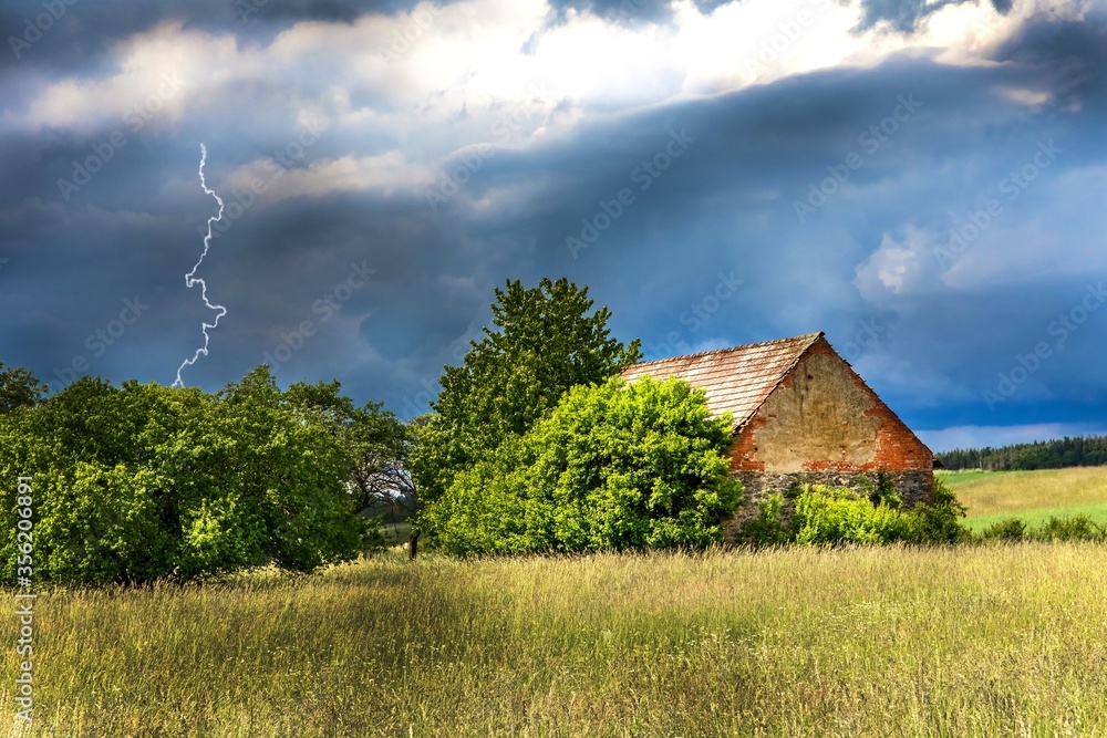 Old barn. Storm clouds over the countryside. Agricultural landscape in the Czech Republic. Strong storm. Old barn. Storm clouds over the countryside. Agricultural landscape in the Czech Republic. Strong storm.