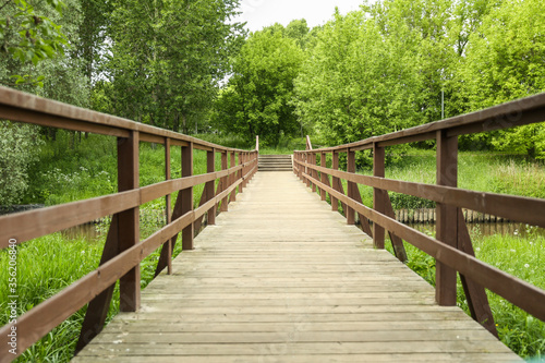 wooden bridge over a small river in summer