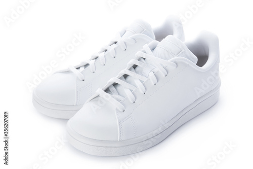Pair of stylish sneakers isolated on white background. White casual shoes