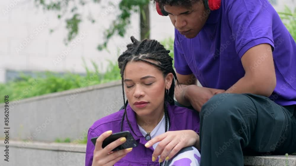 MS Woman and man looking at smart phone / Milan, Italy MS Woman and man looking at smart phone / Milan, Italy