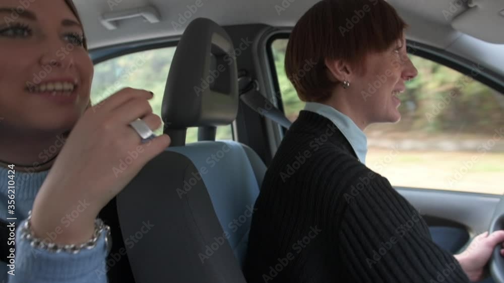 MS Women driving in car and dancing / Rezzago, Como, Italy MS Women driving in car and dancing / Rezzago, Como, Italy