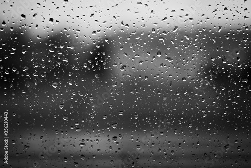 Raindrops on window surface  black and white