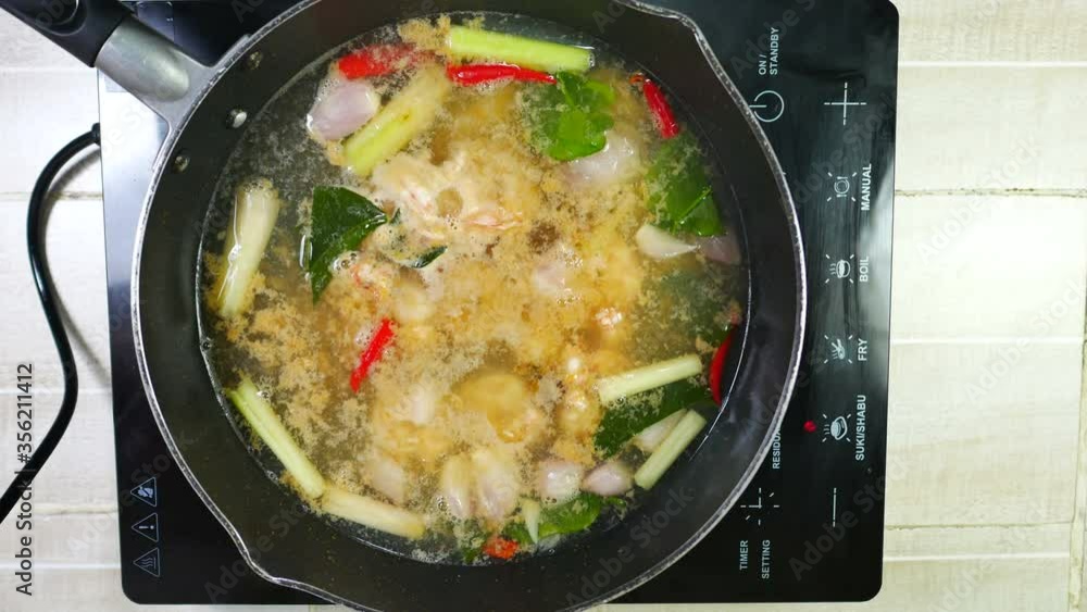 boiled water with shrimp ,kaffir lime leaves, chilli,galangal, lemon grass and small shallot onion,ingredient cooking Tom Yam Kung (prawn spicy soup) ,popular traditional famous Thai food cuisine boiled water with shrimp ,kaffir lime leaves, chilli,galangal, lemon grass and small shallot onion,ingredient cooking Tom Yam Kung (prawn spicy soup) ,popular traditional famous Thai food cuisine