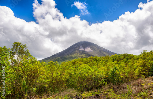 Amazing view of beautiful nature of Costa Rica with smoking volcano Arenal background. Panorama of volcano Arenal La Fortuna, Costa Rica. Central America.