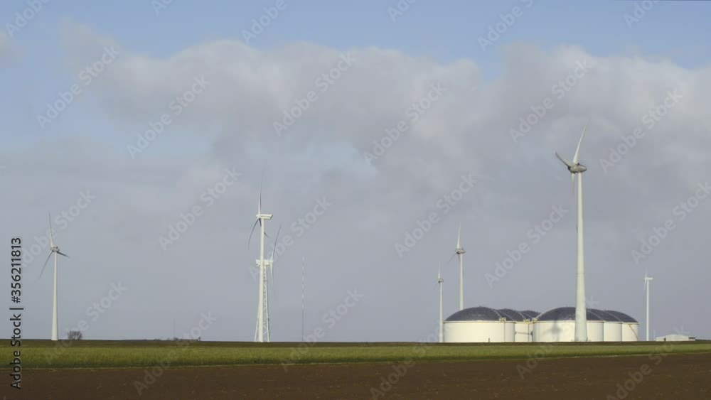 WS Wind turbines besides crude oil storage in Eemshaven harbor area / Delfzijl, Groningen, Netherlands WS Wind turbines besides crude oil storage in Eemshaven harbor area / Delfzijl, Groningen, Netherlands