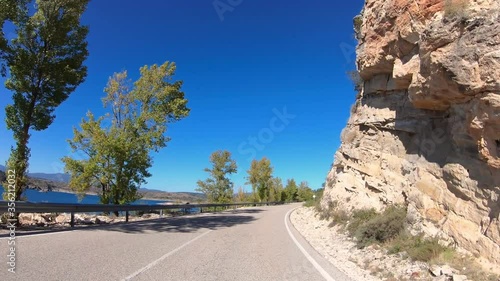 CM-1001 paved road along the Alcorlo reservoir in the Bornova riverbed next to San Andres del Congosto, province of Guadalajara, Castilla-La Mancha, Spain photo