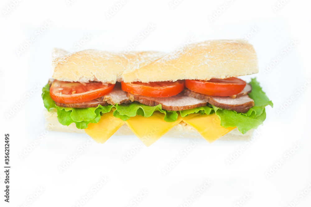 Big tasty sandwich with tomato lettuce with soap and ham on a white plate Big tasty sandwich with tomato lettuce with soap and ham on a white plate