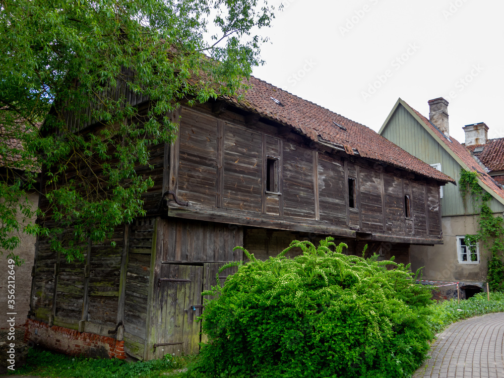 Historical log building with red tiles roof in Kuldiga, Latvia Historical log building with red tiles roof in Kuldiga, Latvia