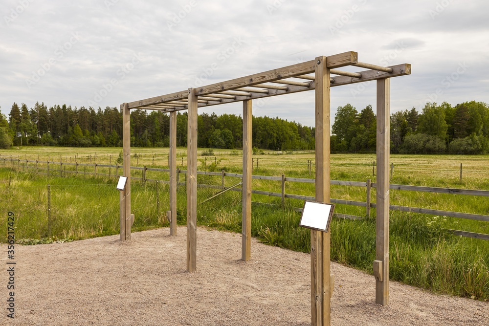 View of horizontal bars for outdoor exercises on green grass lawn background. Health concept. Sweden. Europe.